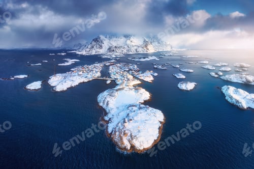 Preview: Aerial view of snowy Lofoten islands, Norway in winter at sunset