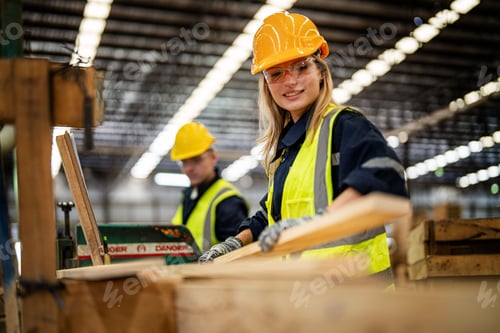 Preview: woman worker carpenter checking the quality of wooden products a