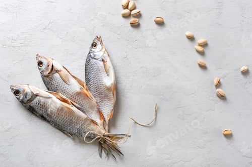Preview: Salted and dried carp. Fish tied with twine, and scattered pistachios
