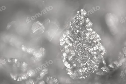 Preview: Close up shot of snow crystals illuminated by sunlight. Winter background. Macro of real snowflake