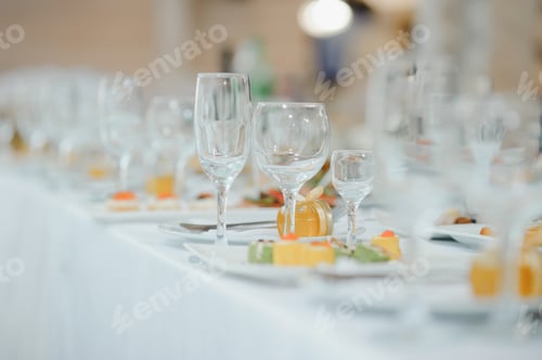Preview: beautifully laid tables with glasses and appliances at morning in restaurant.
