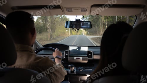 Preview: Rear view shot of young couple driving on country road. Traveling and vacation concept