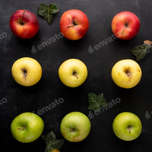 Preview: top view of pattern of apples decorated with leaves on black background