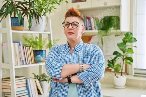 Preview: Portrait of smiling confident middle-aged woman in glasses with red haircut