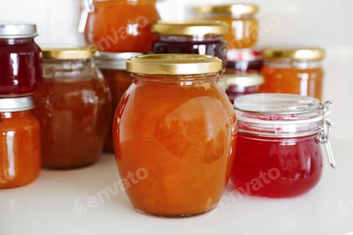 Preview: Jars with different sweet jam on table