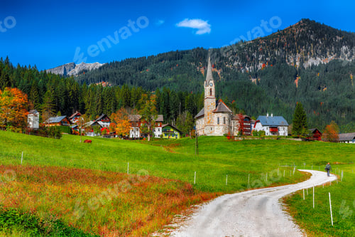 Preview: Alpine green fields and traditional wooden houses view of the Gosau village at autumn sunny day.