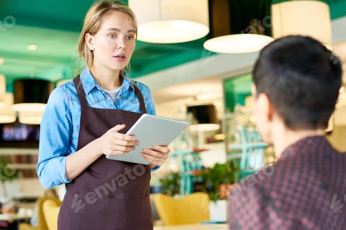 Preview: Young Waitress Taking Orders in Cafe
