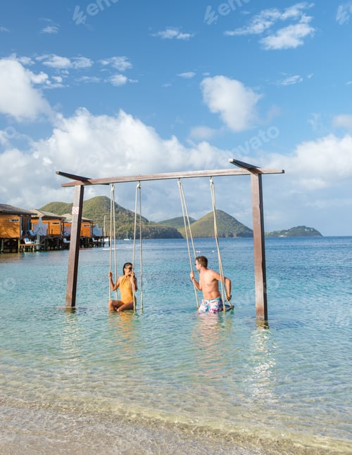 Preview: Couple in a swing on the beach of the tropical Island Saint Lucia or St Lucia Caribbean
