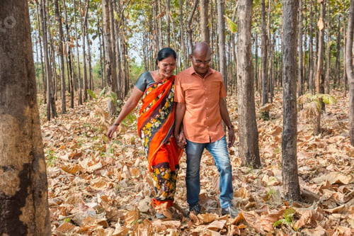 Preview: Happy Indian senior couple walking in forest