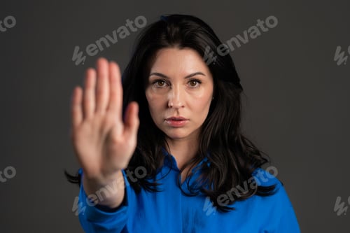 Preview: Adult woman disapproving with NO hand sign gesture. Denying, rejecting, disagree, portrait of lady