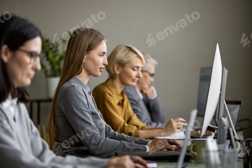Preview: Caucasian Young Women Working on Computers in Modern Office Environment