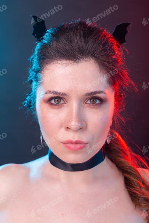 Preview: Halloween, holidays and carnival concept - vamp woman in collar and bat's ears in gothic style