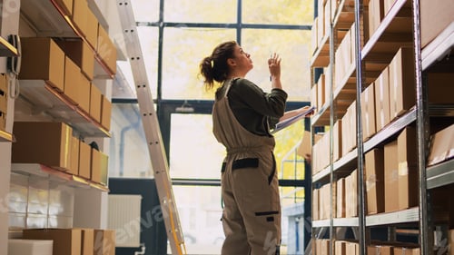 Preview: Young supervisor checking boxes logistics