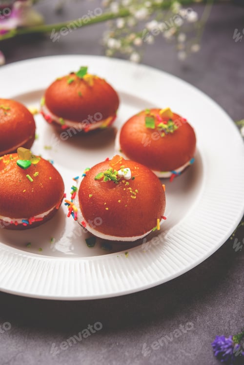 Preview: Malai Chop or Cream sandwich made using filling Rasgulla or Gulab jamun sweet is a Bengali sweet