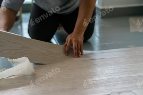 Preview: Vinyl floor installation, worker, DIY at home.