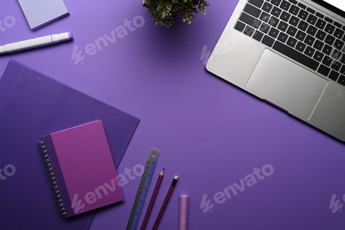 Preview: Flat lay computer laptop, potted plant and stationery on purple background.