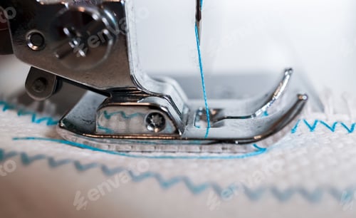 Preview: close-up of sewing machine needle with blue thread