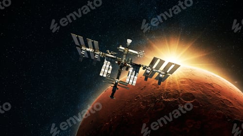 Preview: ISS spacecraft flies against the backdrop of dawn light and red planet Mars with craters