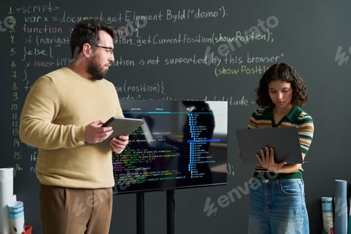 Preview: Caucasian Man and Young Adult Woman Collaborating on Programming