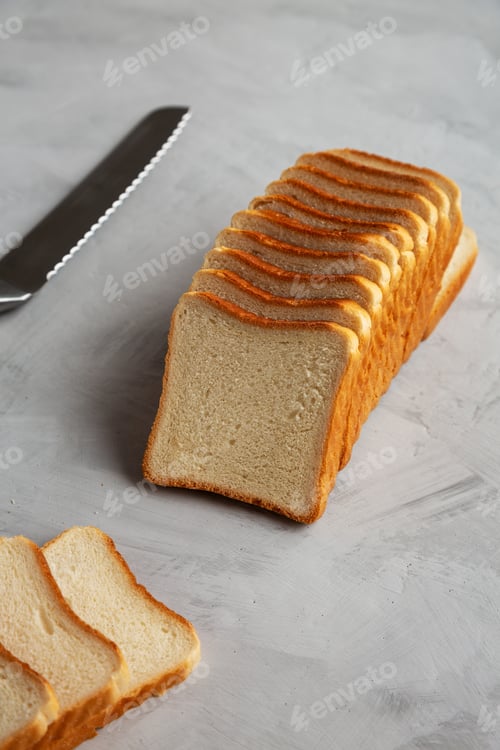 Preview: Sliced Whole Wheat White Bread on a gray background, side view.