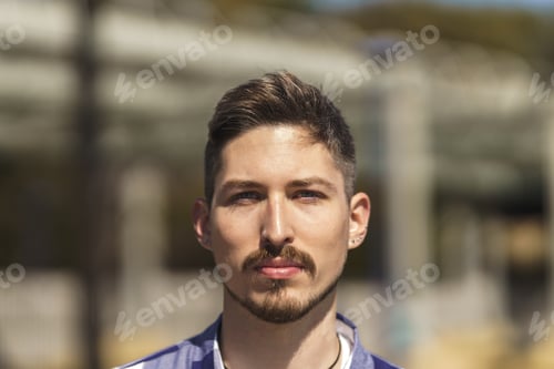 Preview: portrait of young white man with beard, piercings and blue eyes