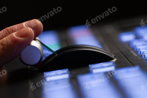 Vista previa: Hand operating video production switcher, in studio station, audio and video production switcher