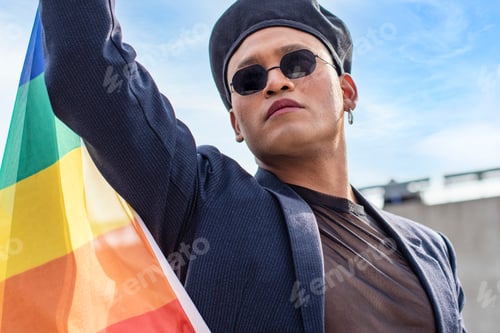 Preview: Gay activist holding a LGBT rainbow flag. Concept of Pride. Pride month.