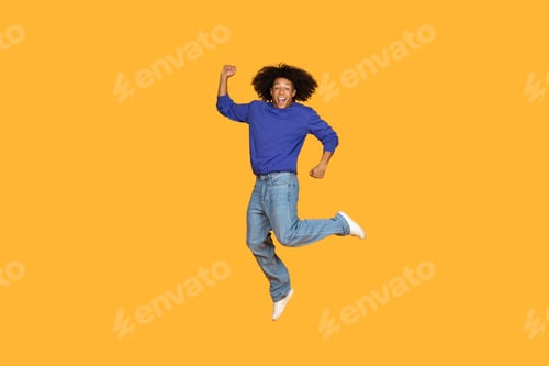 Preview: Happy Man Jumping In The Air Against Yellow Background