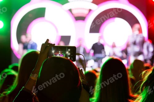 Preview: Crowd Enjoying Concert with Phone Capturing the Moment