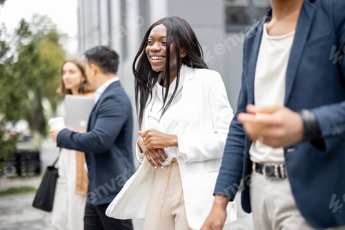 Preview: Business team walking and talking on city street