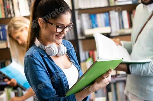 Preview: Happy young university students friends studying with books at university