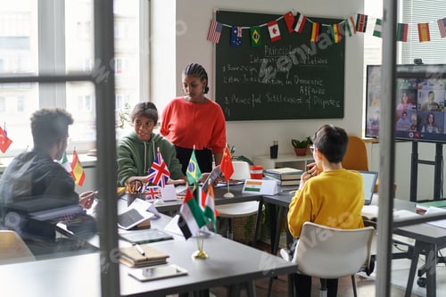 Preview: Students talking to teacher in the classroom