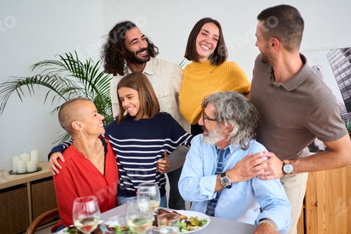 Preview: Portrait of smiling Caucasian people looking affectionately at each other embraced together at home.