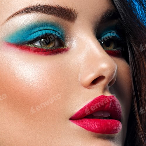 Preview: Portrait of beautiful young woman with bright blue makeup.