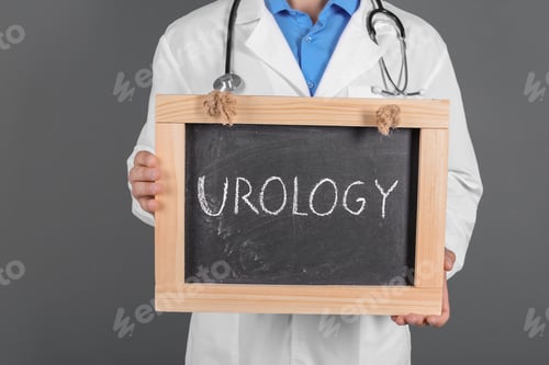Preview: Male doctor holding chalkboard with word UROLOGY on grey background