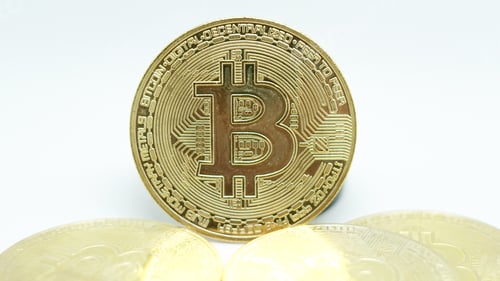Preview: Closeup shot of golden bitcoins on a white background