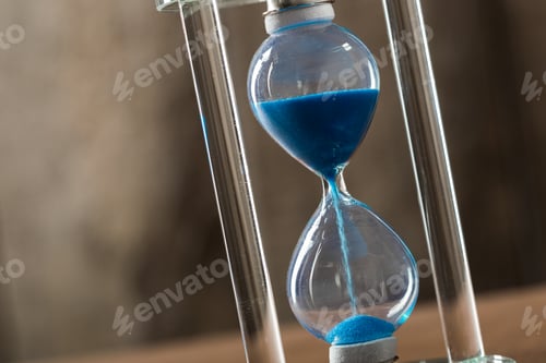 Preview: Time is passing. Blue hourglass close up