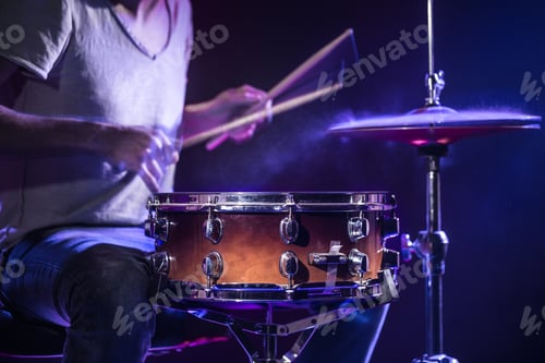 Preview: A drummer plays drums on a blue background.