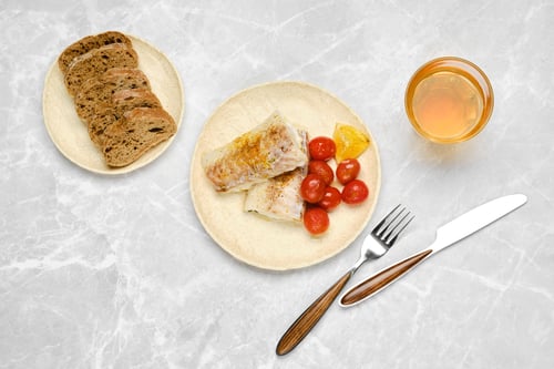 Preview: Delicious breakfast featuring fish, tomatoes, and whole grain bread on a marble table