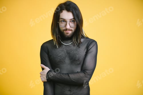 Preview: Young gay man is standing in the studio and posing for a camera.
