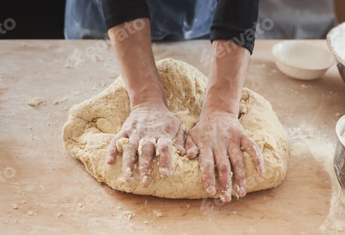 Preview: Chef hands kneading dough on wooden table