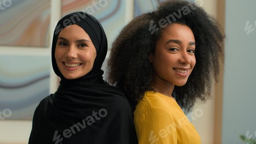 Preview: Multiethnic girls women two colleagues business partners happy businesswomen ladies portrait at