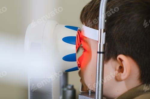 Preview: Child undergoing vision diagnostics with modern equipment in ophthalmology clinic