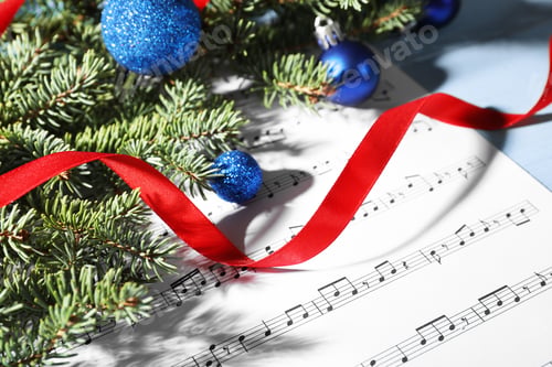 Preview: Composition with Christmas decor and music sheets on table, closeup