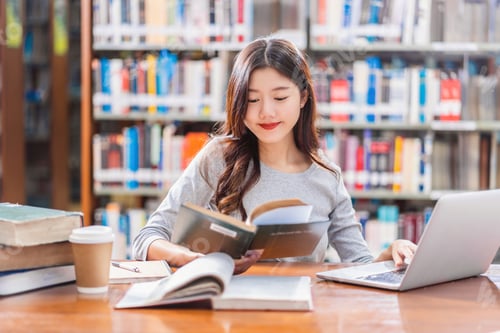 Preview: Asian young Student in casual suit doing homework and using technology laptop