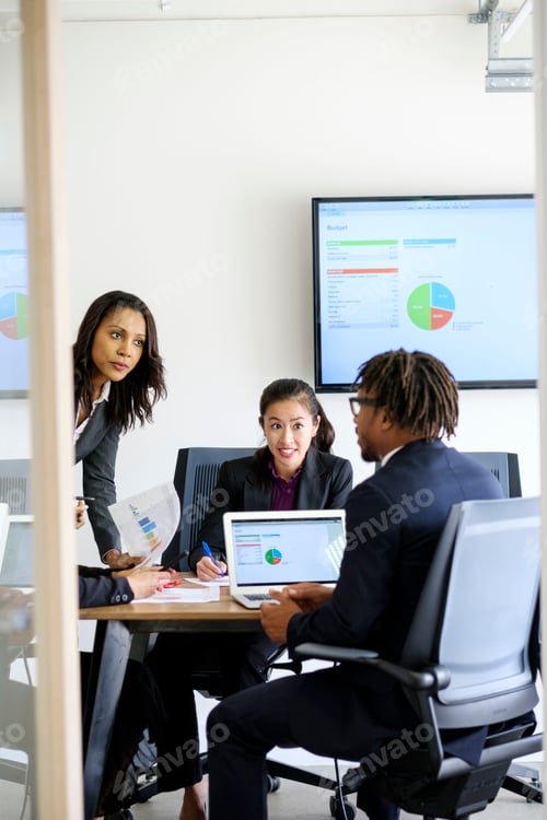 Preview: Businessman and businesswomen, sitting in office, having discussion, looking at data