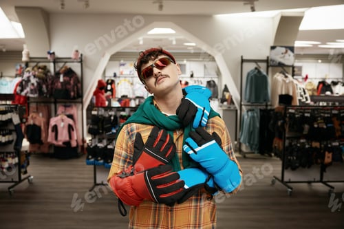 Preview: Cool hipster sportsman standing over sports clothing store interior