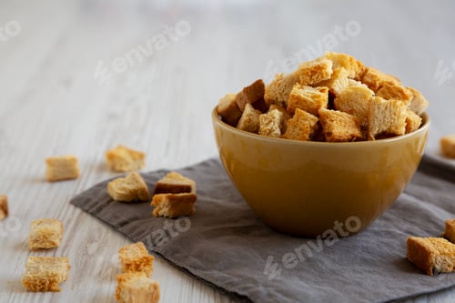 Preview: Homemade Crispy Bread Croutons in a Bowl, side view. Close-up.