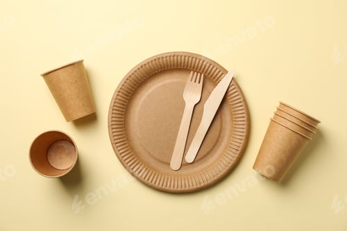 Preview: Flat lay with eco - friendly tableware on beige background, space for text