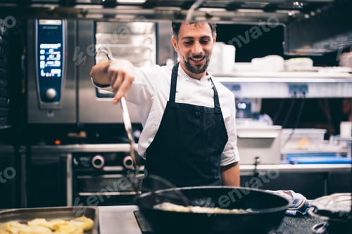 Preview: Cook at work in a restaurant kitchen
